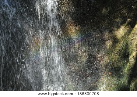 Rainbow at the waterfall Millomeris in the mountains in Cyprus