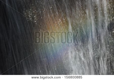 Rainbow at the waterfall Millomeris in the mountains in Cyprus