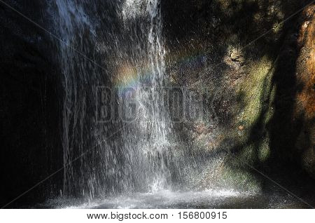 Rainbow at the waterfall Millomeris in the mountains in Cyprus