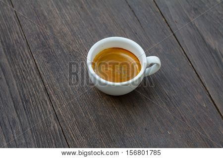 Espresso double shot on wood background vintage tone shallow depth of field
