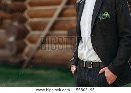 Unrecognizable groom standing outdoor, free space for text or advertisement. Man in black suit keep his hands in pockets. Nervous, waiting for bride, keeping calm fiancee