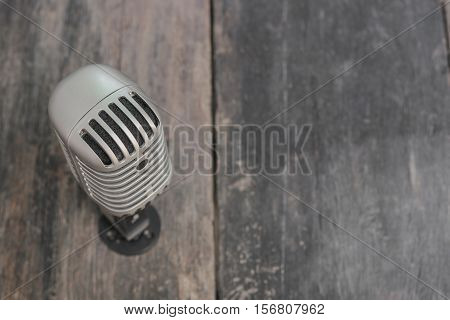 Retro microphone. Vintage style on the wooden floor background :Select focus with shallow depth of field.