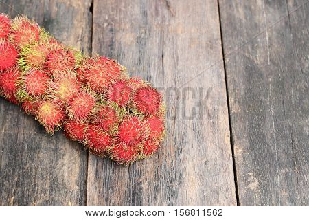 rambutan sweet fruit fresh on wood background :Select focus with shallow depth of field.