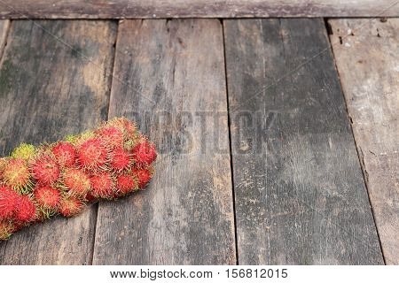 rambutan sweet fruit fresh on wood background :Select focus with shallow depth of field.