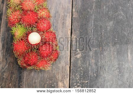 rambutan sweet fruit fresh on wood background :Select focus with shallow depth of field.