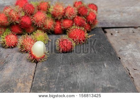 rambutan sweet fruit fresh on wood background :Select focus with shallow depth of field.