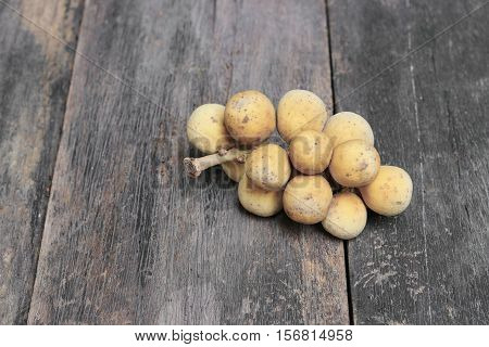 southern langsat wollongong on wooden background tropical fruit at South of Thailand
