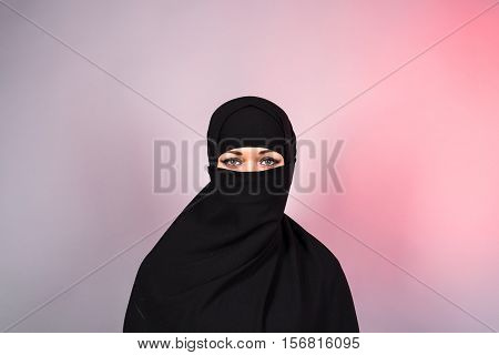 Beautiful Muslim girl wearing black burqa closeup.