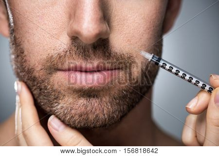 Man during surgery filling facial wrinkles
