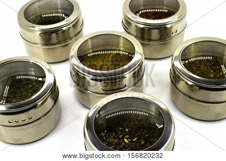Spices on a white background close-up in round cans