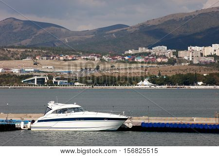 white yacht at the sea mooring. city in the background