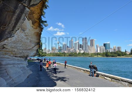 Sydney Australia - October 23 2016: Unrecognisable people look at Sydney central district skyline from the Rosa Botanic Gardens in Sydney New South Wales Australia