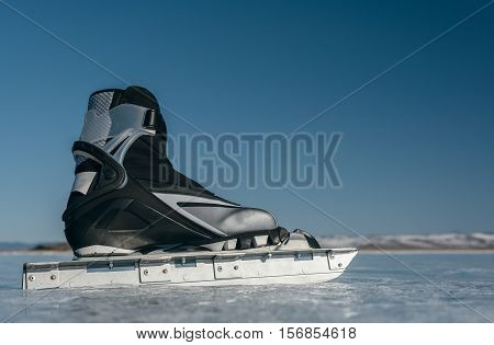 Tourists travel to Norway hiking ice skating on the frozen lake. Special long skate for long distances. Mounting under the ski boots. Location of Lake Baikal action. The Russian called Bayes or Loft.