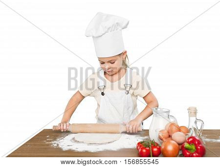 Happy little chef smeary with flour stretching the dough
