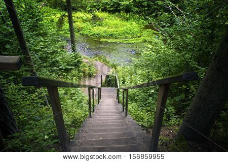 Old wooden stairs. Descent from the wood to the river