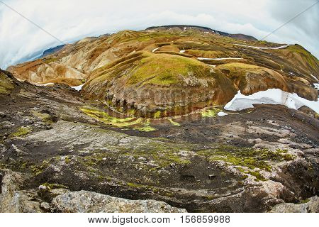 Valley National Park Landmannalaugar. On the gentle slopes of the mountains are snow fields and glaciers. Magnificent Iceland in the August