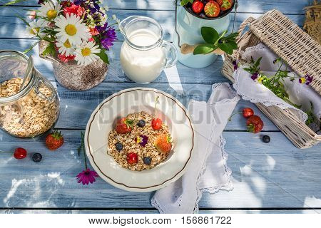 Preparations For Breakfast In The Garden On Old Wooden Table