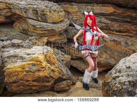 Beautiful female character with two swords in mountain area. Fashion model girl cosplay character