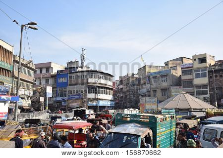 NEW DELHI, INDIA, FEBRUARY 02, 2016 - Unidentified crowd of people, cars, rickshaws and motorbikes in the busy area of Chandni Chowk in the old part of the city