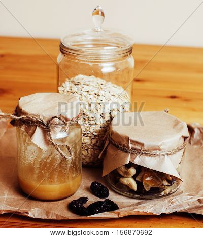 real comfort wooden kitchen with breakfast ingredients close up in glass, honey, oatmeal, milk, muesli, morning food