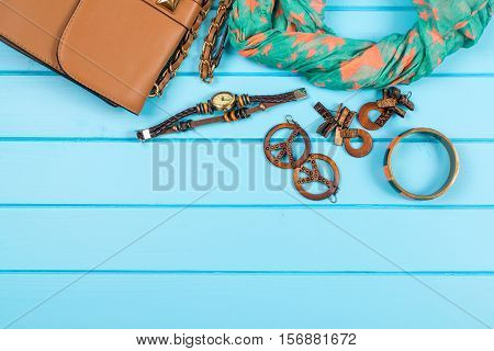 Set of the fashionable women's acsessories. Blue wooden background.