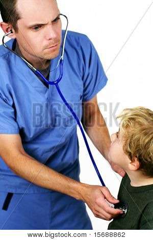 A medical worker listening to a young boy's heart