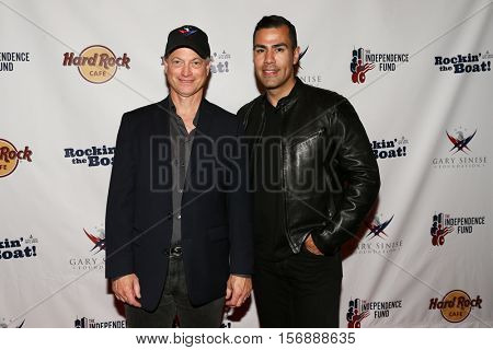 NEW YORK - MAY 21: Actors Gary Sinise (L) and J. W. Cortes attend a benefit concert at the Hard Rock Cafe on May 21, 2015 in New York City.