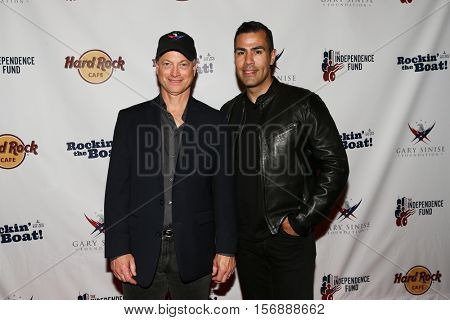 NEW YORK - MAY 21: Actors Gary Sinise (L) and J. W. Cortes attend a benefit concert at the Hard Rock Cafe on May 21, 2015 in New York City.