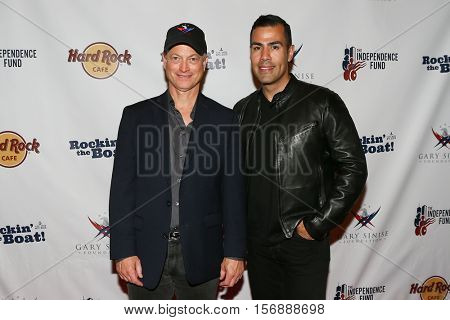 NEW YORK - MAY 21: Actors Gary Sinise (L) and J. W. Cortes attend a benefit concert at the Hard Rock Cafe on May 21, 2015 in New York City.