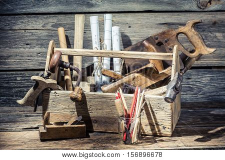 Hammer, Saw And Paper Scheme In The Carpentry Workbench