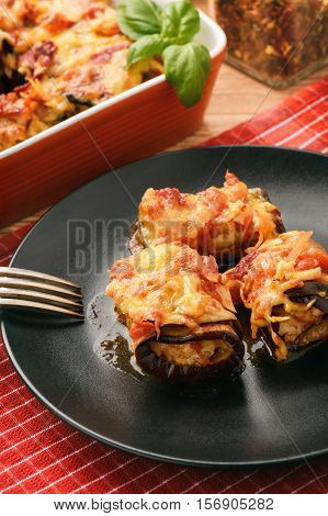 Roasted eggplants stuffed with minced meat and baked with tomatoes and cheese.