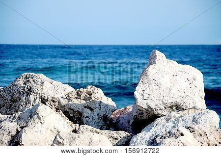 The cliffs on the shore. Rocks on the beach