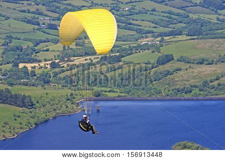 Paraglider flying above Cray reservoir in the Brecon Beacons