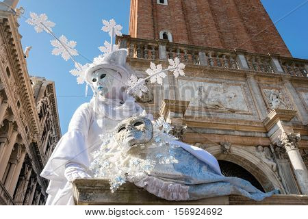 ENICE, ITALY - FEBRUARY 16, 2015: An unidentified person wearing a winter theme costume, posing in San Marco square during the Carnival of Venice