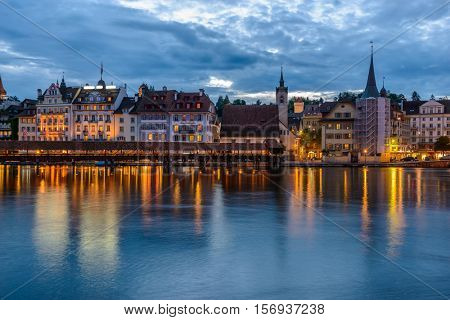 Night view towards Chapel Bridge (Kapellbruecke) together with the octagonal tall tower (Wasserturm) it is one of the Lucerne's most famous tourists attraction