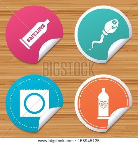 Round stickers or website banners. Safe sex love icons. Condom in package symbol. Sperm sign. Fertilization or insemination. Heart symbol. Circle badges with bended corner. Vector