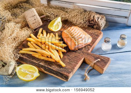 Hot French Fries With Salmon Served On Plate