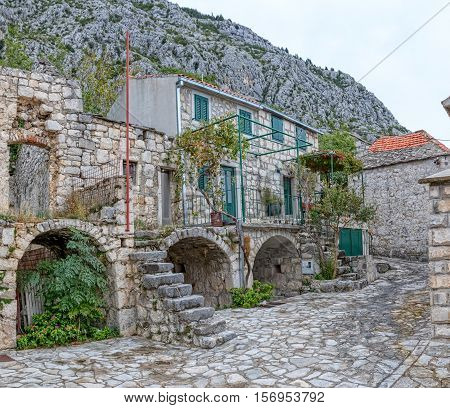 Small narrow street in Tucepi village in the slope of a mountain Biokovo.