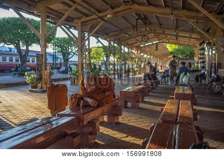 Nakhon Lampang, Thailand - November, 13, 2016 : Unidentified old monks thai passenger waiting for time to train at Nakhon Lampang Railway Station in Nakhon Lampang, Thailand.