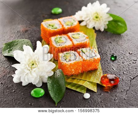 California Maki Sushi with Masago - Roll made of Crab Meat, Avocado, Cucumber, Japanese Mayonnaise inside. Masago (smelt roe) outside