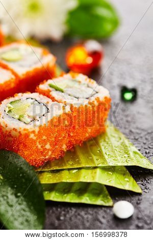 California Maki Sushi with Masago - Roll made of Crab Meat, Avocado, Cucumber, Japanese Mayonnaise inside. Masago (smelt roe) outside