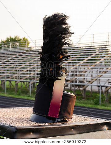 A Customized Shako With Plume Resting On A Drum Majors Stand During A Break In Rehearsal