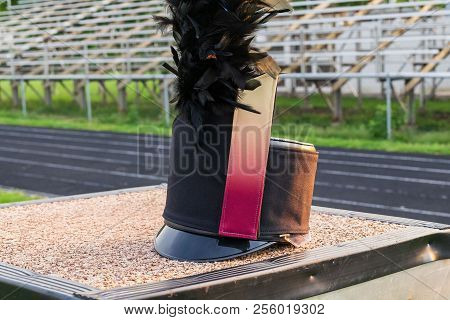 A Customized Shako With Plume Resting On A Drum Majors Stand During A Break In Rehearsal