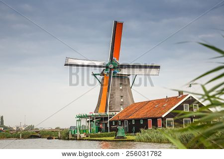 Traditional, Authentic Dutch Windmills At The River Zaam In Zaanse Schans Village.