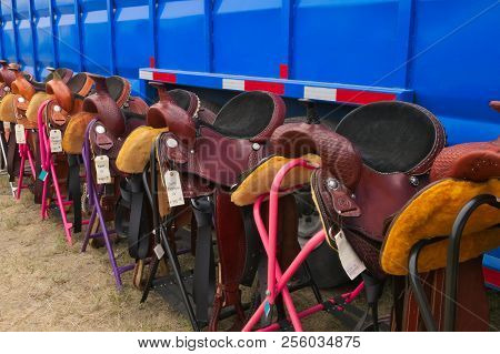 Row Of New Horse Saddles On Display And For Sale At County Fair