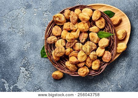 Sun Dried Apricots On Gray Concrete Background. Top View Of Dried Fruits With Copy Space.