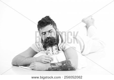Very Deep Sleep Concept. Guy With Sleepy Face Lies On Alarm Clock. Man Not Going To Get Up In Mornin