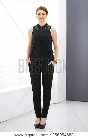 Young Brunette Business Woman Looks Like A Student Girl Working In Office. Caucasian  Girl Standing 