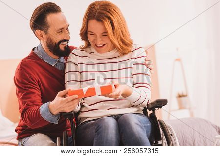 Positive Man Making A Birthday Present For His Wife