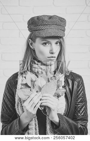 Woman With Autumn Leaves In Leather Jacket. Girl With Orange Leaves At Brick Wall. Season And Autumn